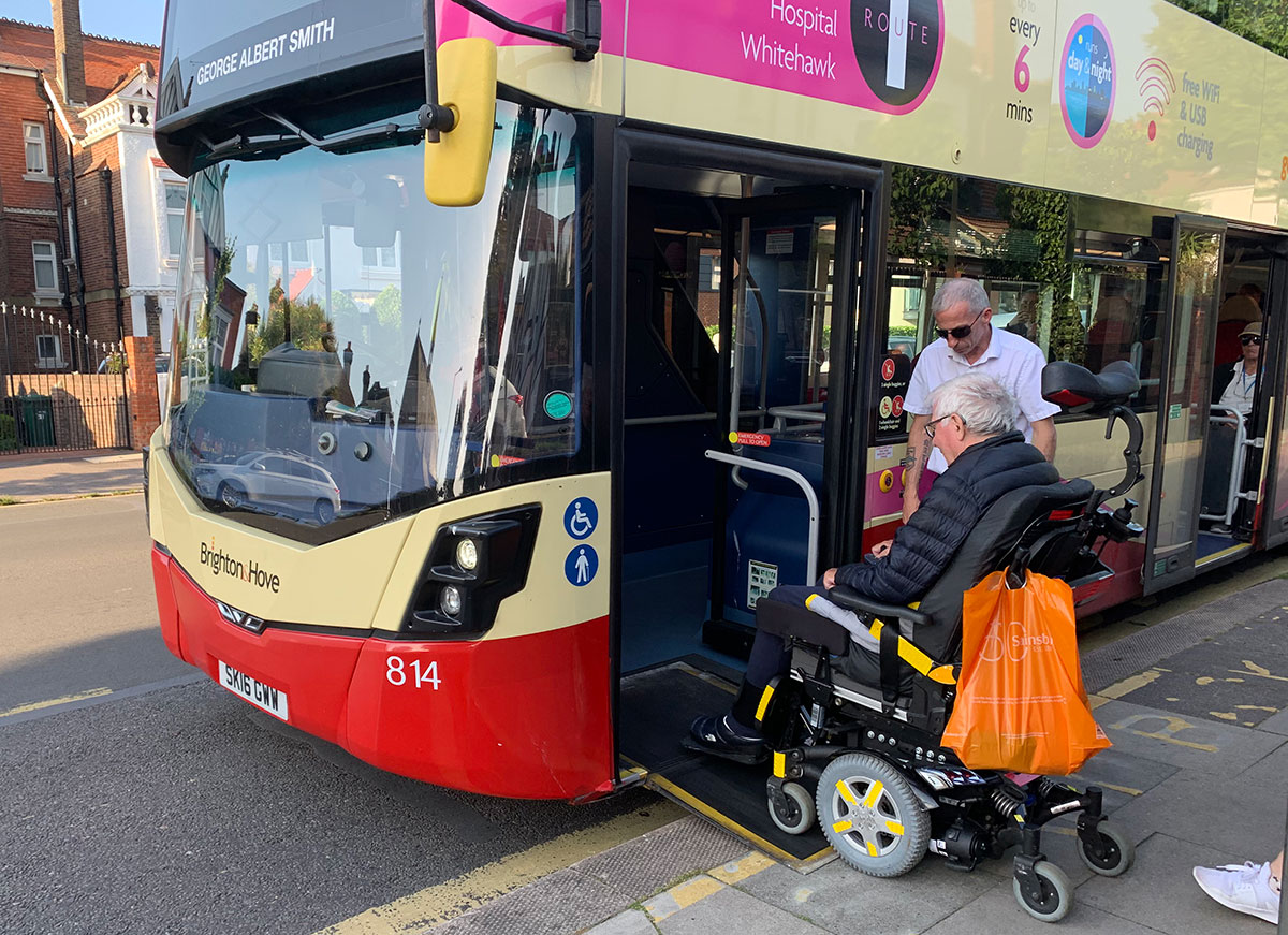 A bus driver assists a passenger in a wheelchair on theBrighton bus service.