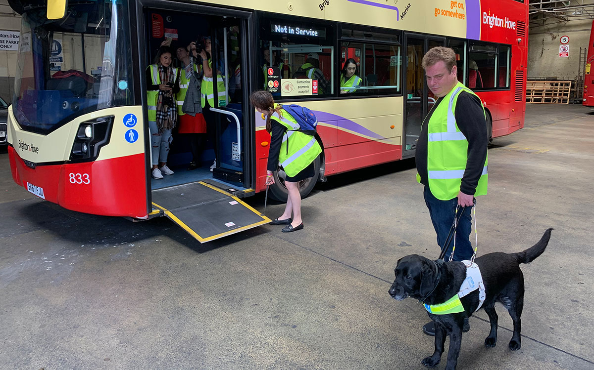 Daniel Walker and his guide dog Pebble joined LU students as they learned about the Brighton bus company's accessibility initiatives during a study abroad program in June 2019.