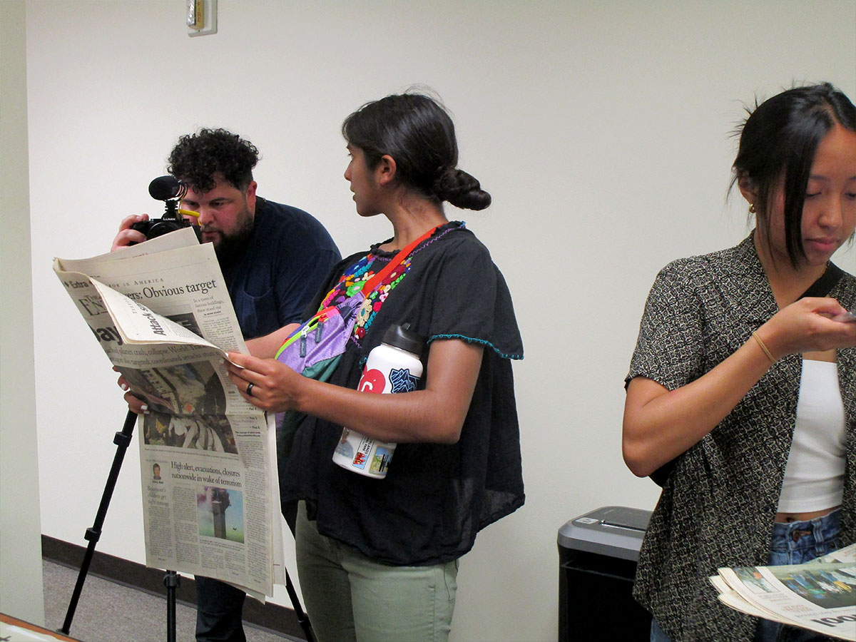 The BYU team looks through local news coverings of natural disasters. UP photo by Maddie Sims.
