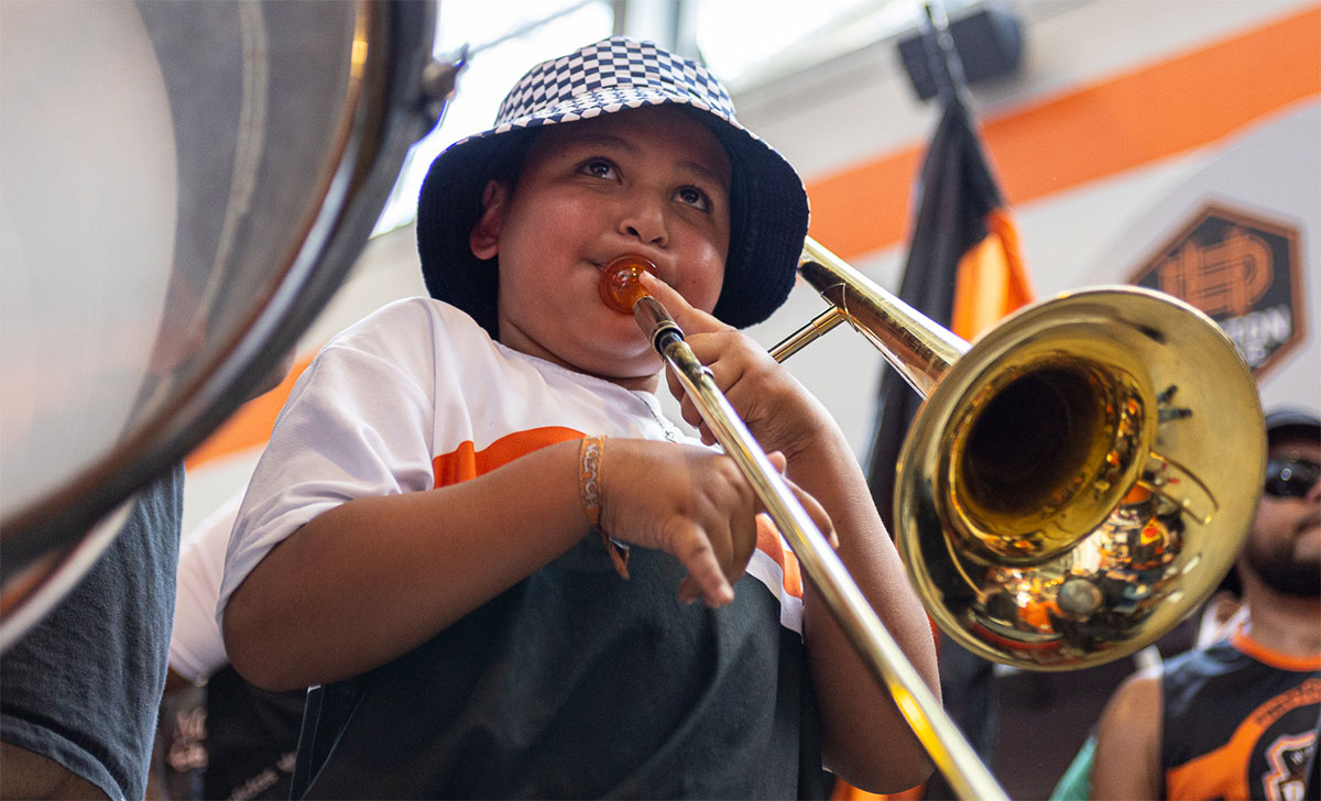 A child plays the trombone during the performance of El Batallon before the match at PNC stadium in Houston, Oct. 9. UP photo by Brian Quijada.