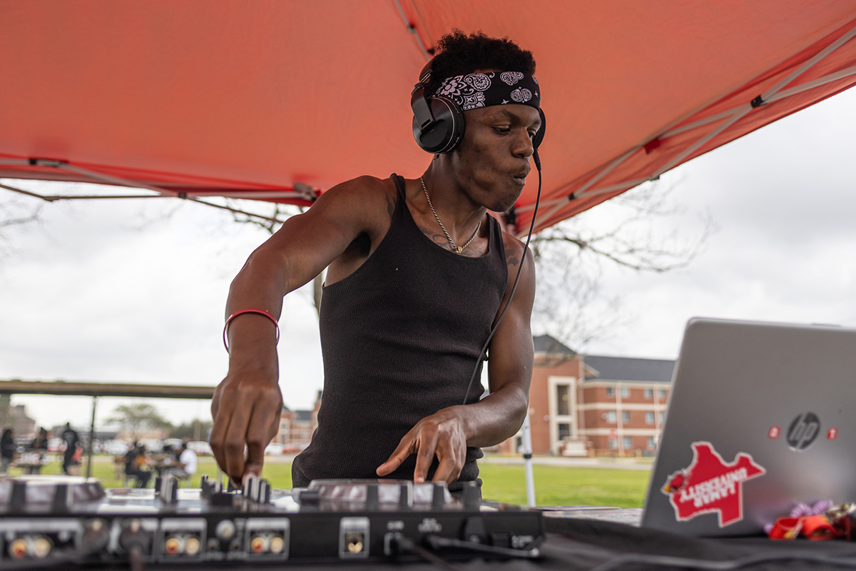 DJ TJ spins the turntables to provide music at the Black History Month Block Party, Feb. 24, at Cardinal Park. UP photo by Brian Quijada.
