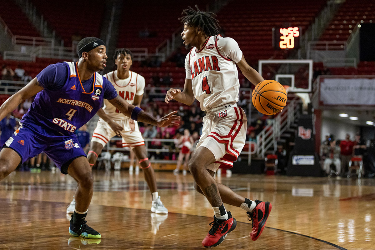 Cardinal guard Chris Pryor dribbles past a Northwestern State defender, Feb. 4, at the Montagne Center. UP image by Brian Quijada.