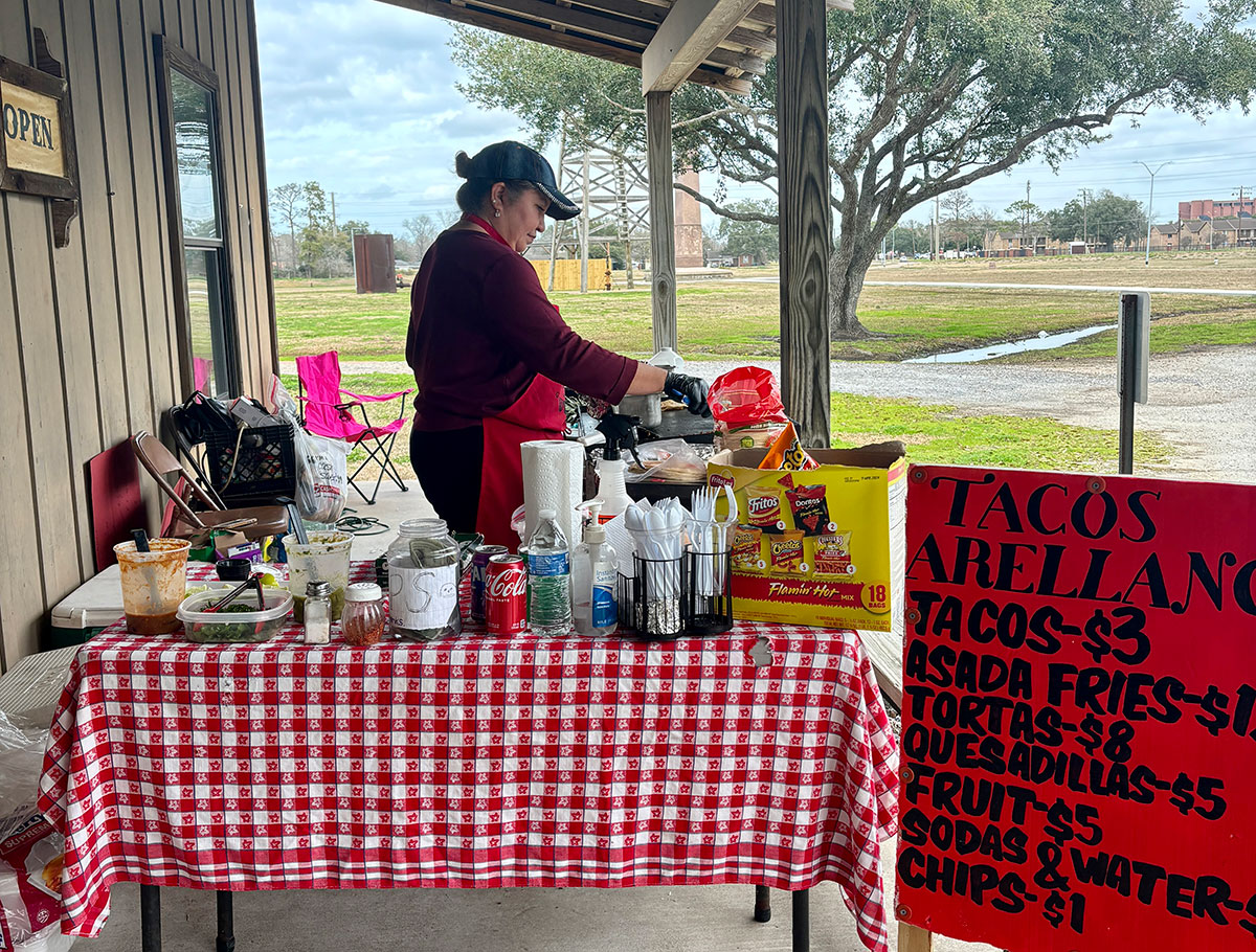 Gloria Arellano, owner of Tacos Y Fruta, serves pork tacos at Spindletop Gladys City Boomtown Museum, Feb. 8. Arellano sells lunches at the museum, 10 a.m.-2 p.m., through Feb. 29. UP photo by Meredith Winkler