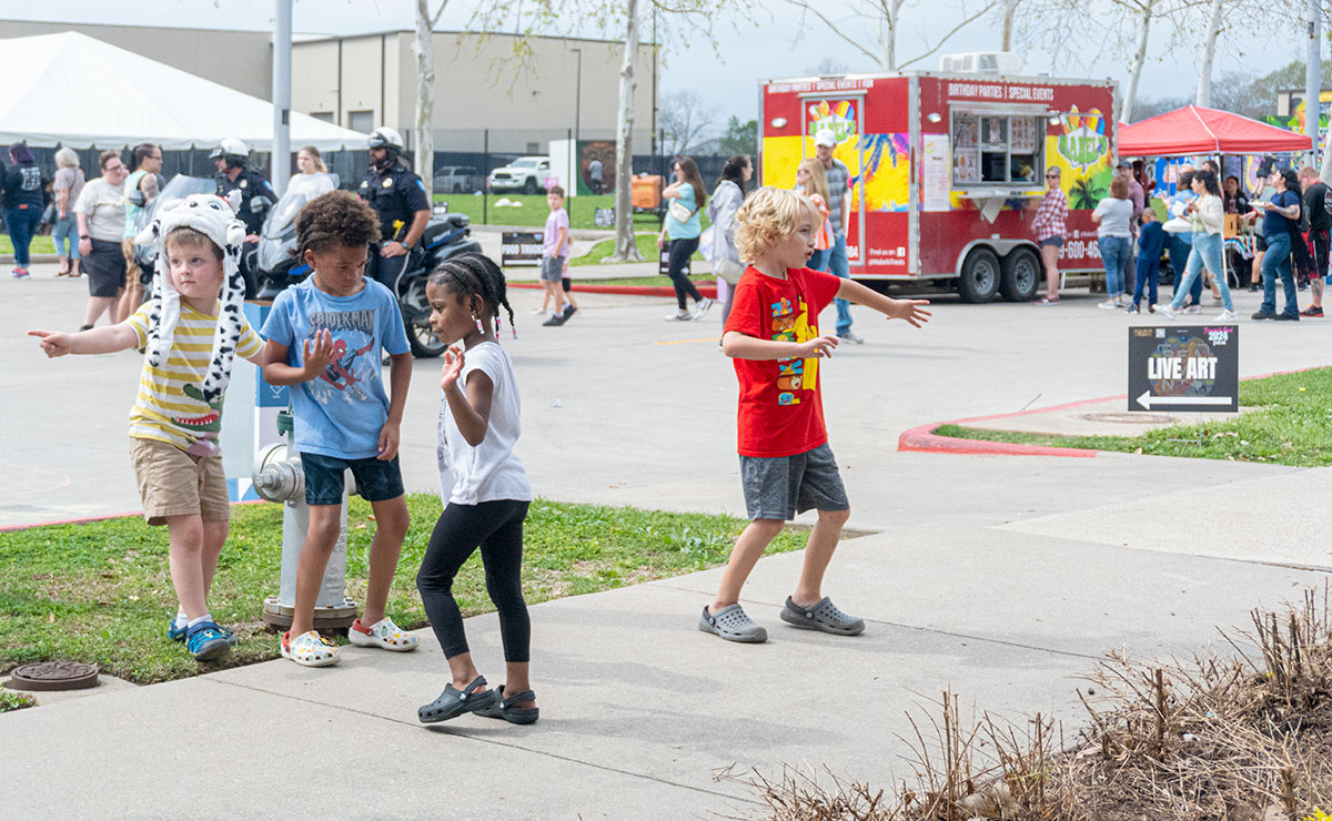 Kids dancing along to the DJ music during Mural Fest 2024, in downtown Beaumont, Mar. 3. UP photo by Carlos Viloria.