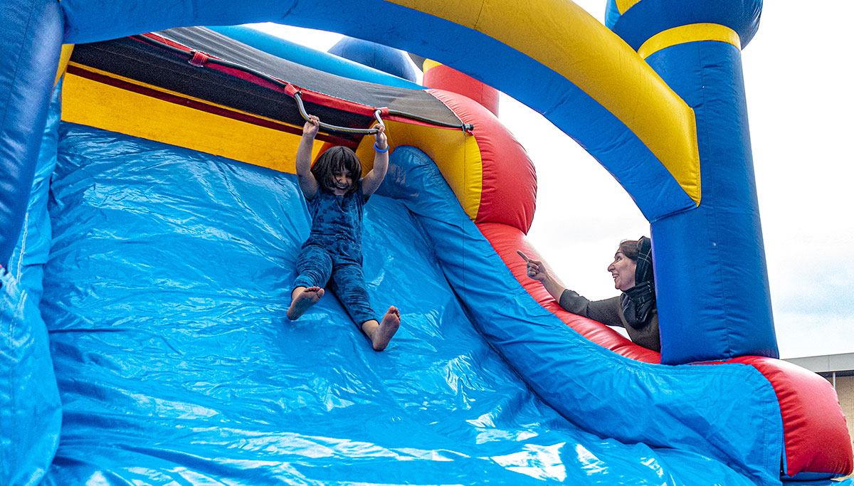 A child going down the bouncy castle slide during Mural Fest 2024, in downtown Beaumont, Mar. 3. UP photo by Carlos Viloria.