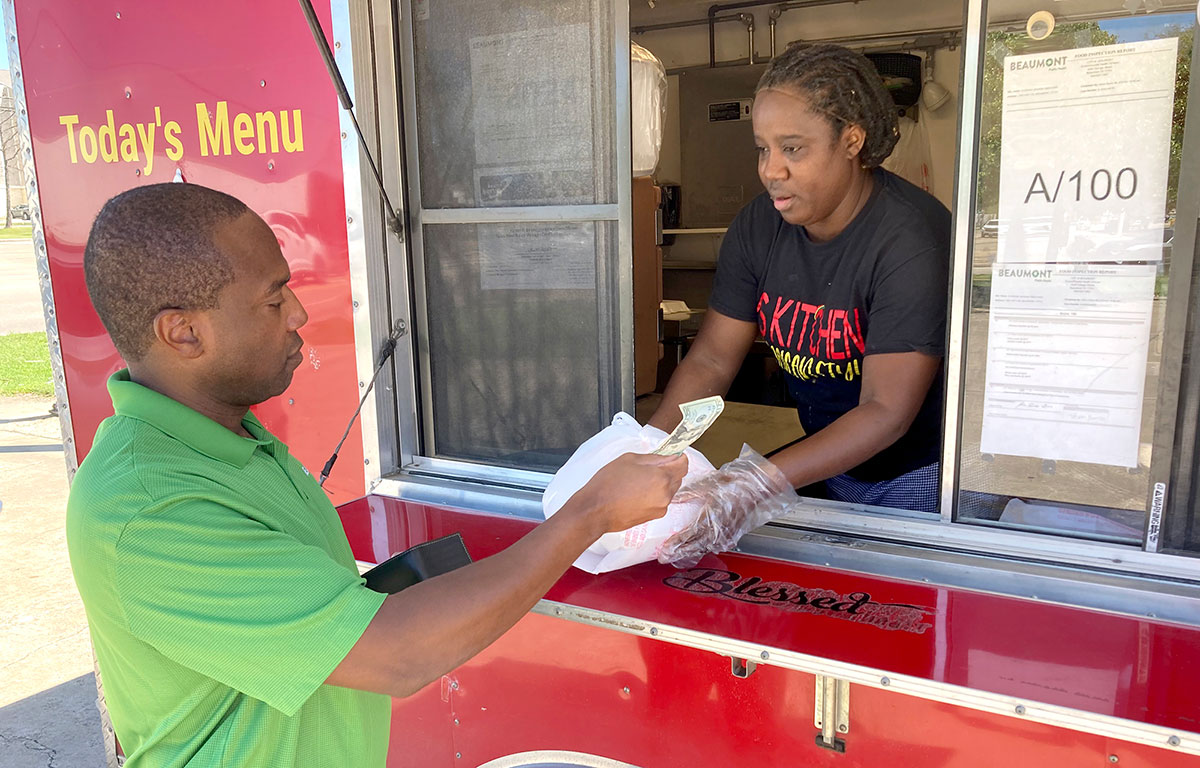 Veron Banks serves a customer home-made Jamaican fare from her food truck. UP photo by Josiah Boyd.
