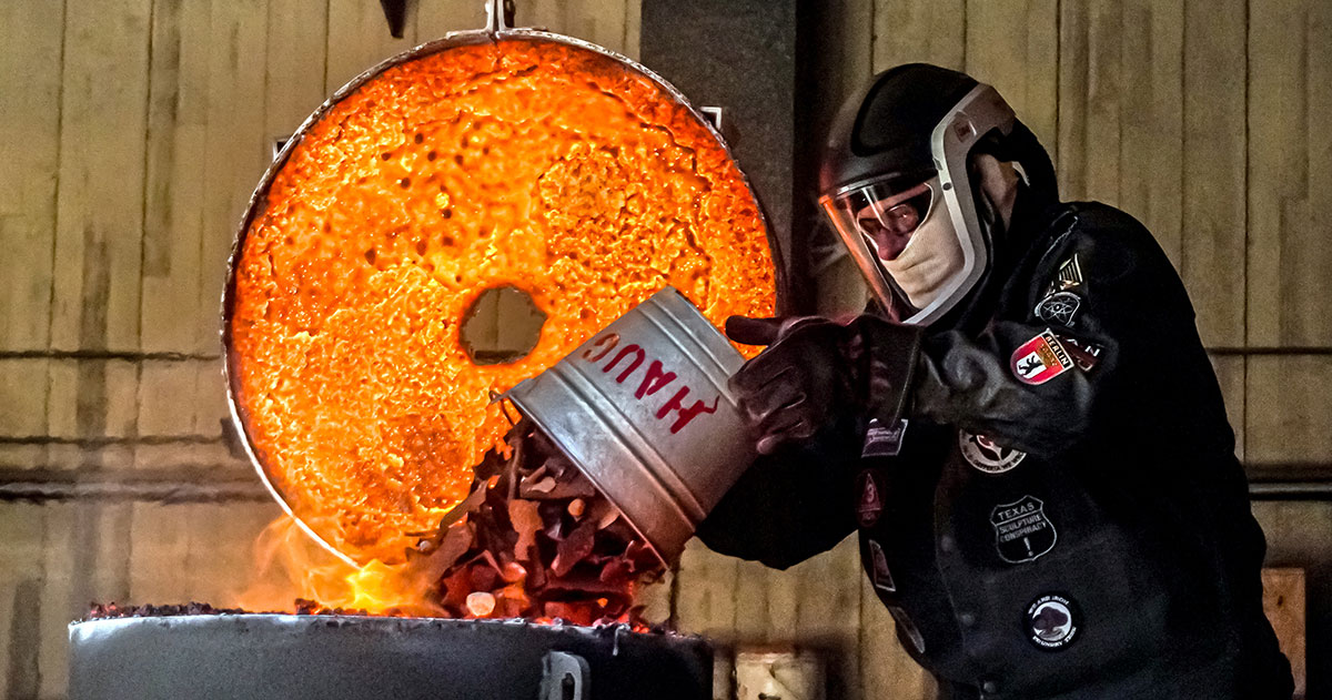 Lamar art professor Kurt Dyrhaug dumps the pieces of iron into the furnace, March 22, at the art foundry. UP photo by Carlos Viloria.