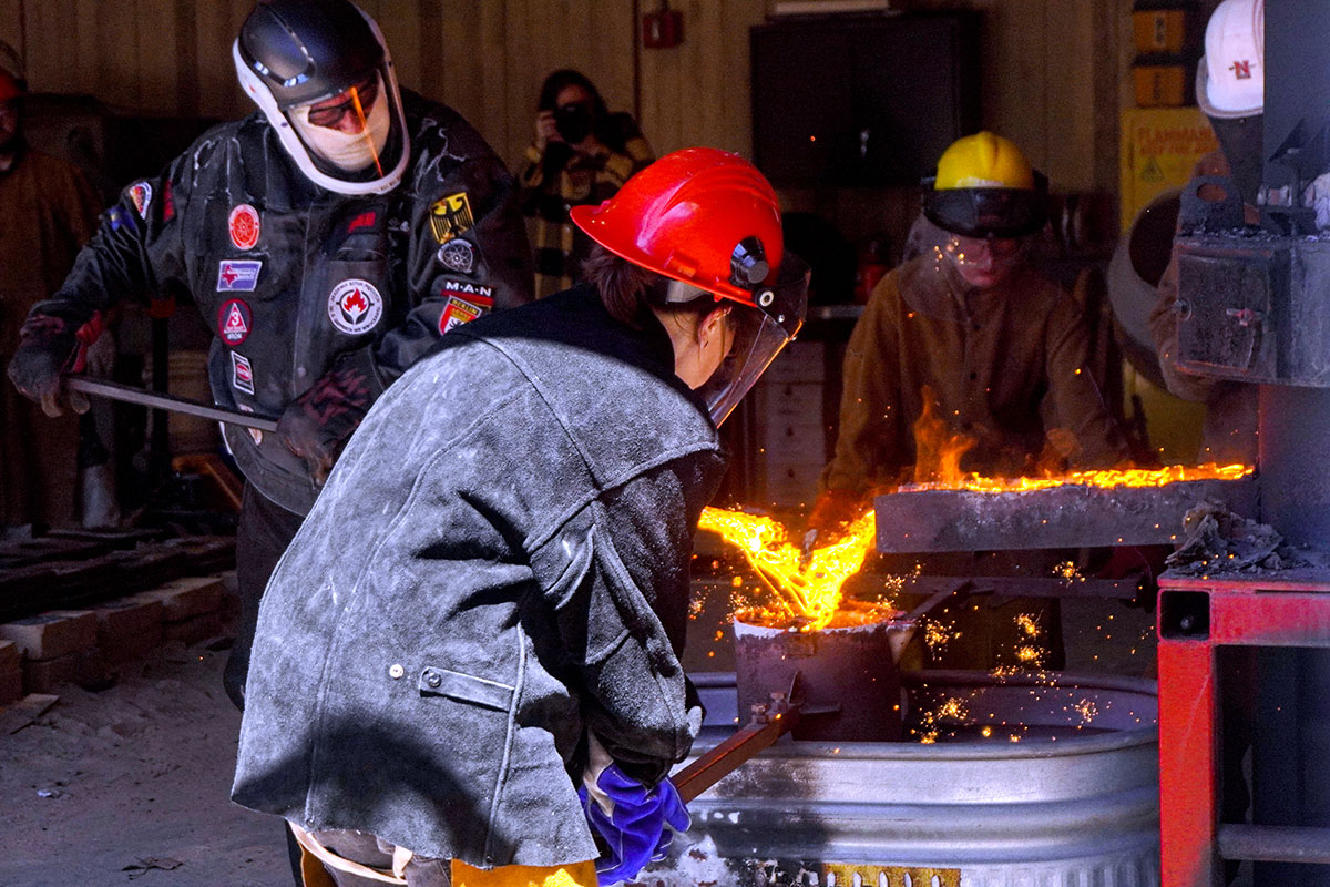 Art students collect the molten iron from the cupula furnace, March 22, at the art foundry. UP photo by Carlos Viloria.